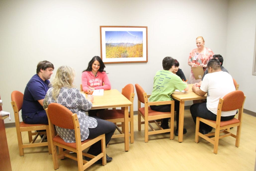 Patients sitting around a table talking